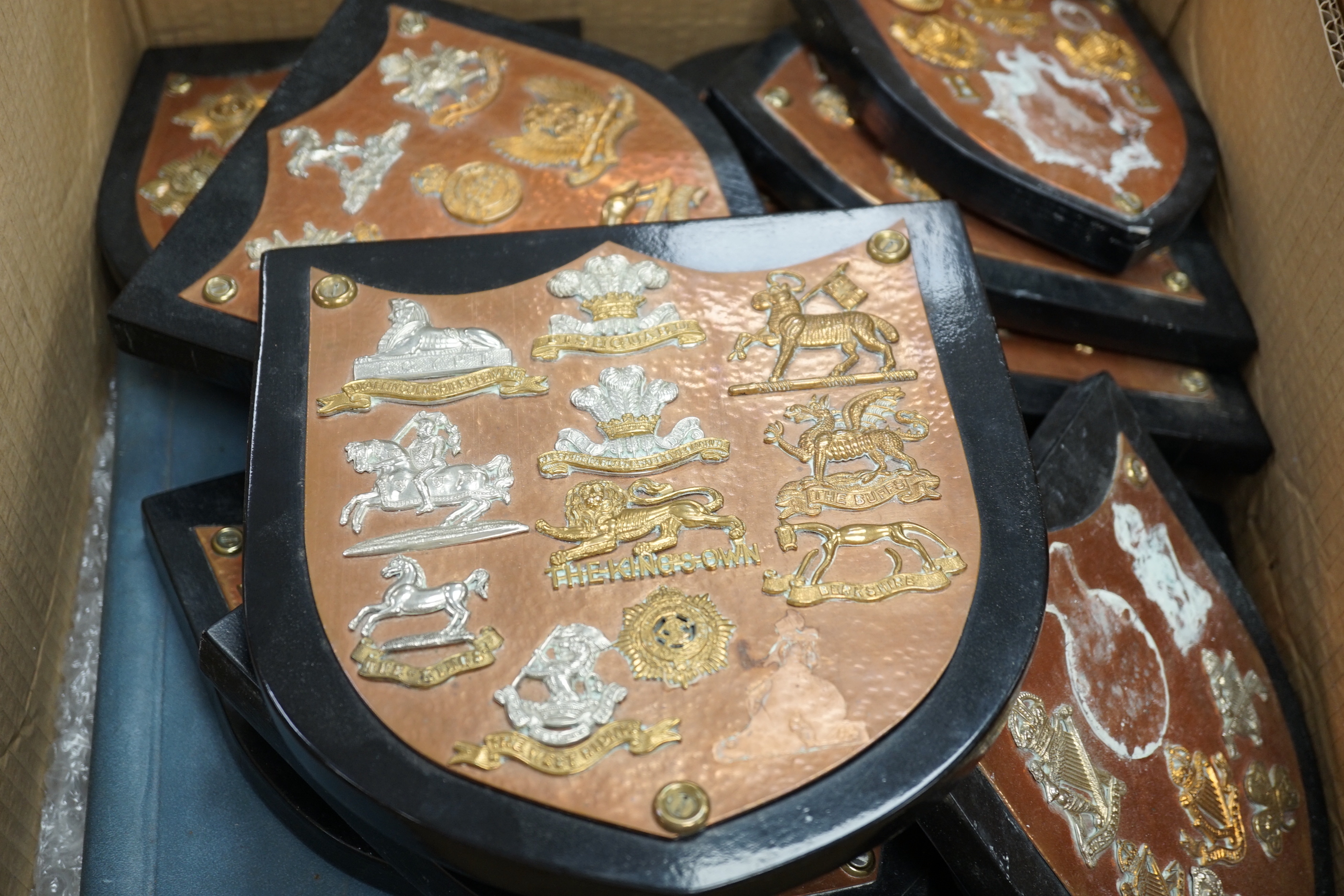 A collection of Military cap badges and buttons